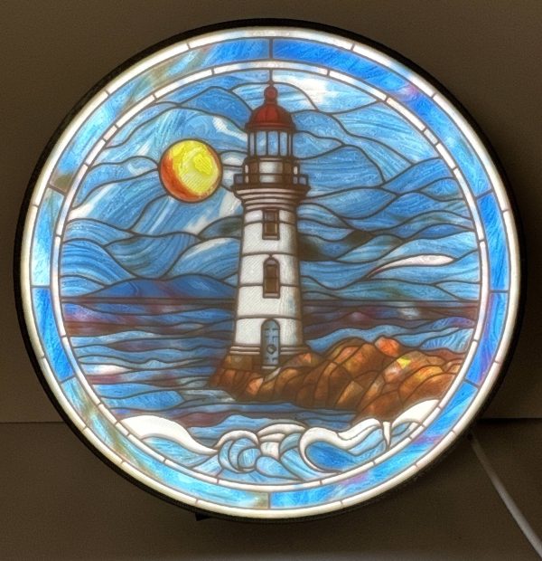 Stained Glass Lighthouse Lithophane of a lighthouse with waves and a sun, set in a circular frame.
